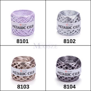 May include: Four spools of metallic yarn in different colors: lavender, silver, gold, and gray. Each spool has a label that reads "YarnArt Metallic Club".