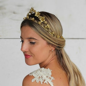 In this image we can see the bride with her porcelain sparkle gold flower crown