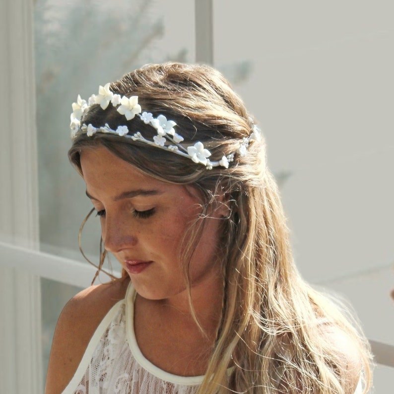 In this image we can see the bride with her porcelain white flower crown