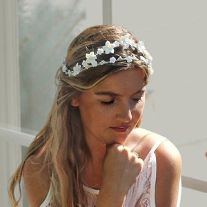 In this image we can see the bride with her porcelain white flower crown