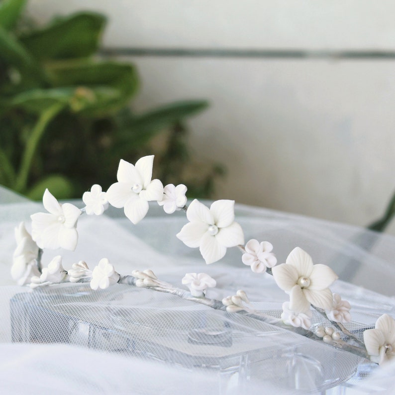 This is a detail photograph of the beautiful and delicate handmade white porcelain flower tiara.
