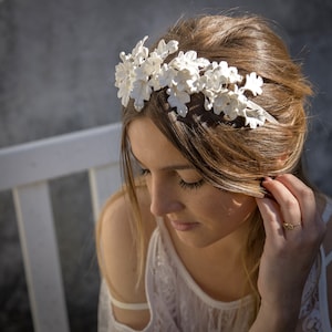 In this image we can see the bride with her tiara of handmade white porcelain flowers and leaves.