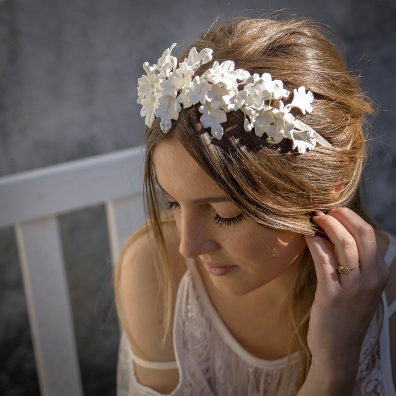 In this image we can see the bride with her tiara of handmade white porcelain flowers and leaves.