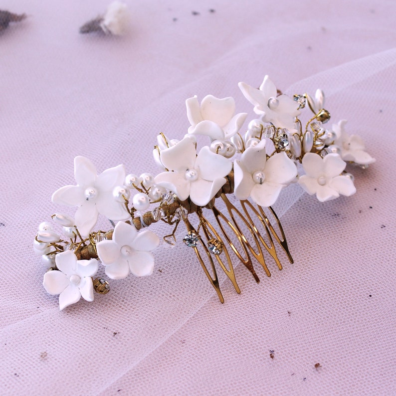 here you can see the hairpiece with white porcelain flowers on a table