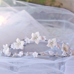 This is a detail photograph of the beautiful and delicate handmade white porcelain flower tiara.