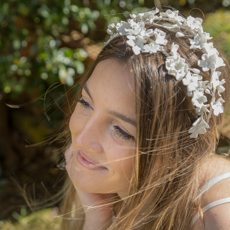 In this image we can see the bride with her handmade white porcelain flower and leaf tiara more closely in profile.