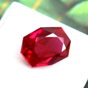 Puede incluir: Una piedra preciosa de color rojo intenso con forma octogonal facetada.