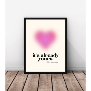 May include: A pink heart-shaped graphic with a blurred effect on a cream background. The text "it's already yours - the universe" is below the heart.