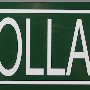 May include: A green street sign with white lettering that reads "MULHOLLAND DRIVE".