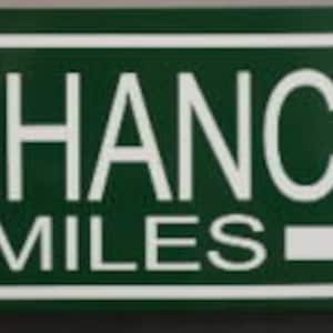 Puede incluir: Un letrero verde y blanco con el texto "LAST CHANCE GAS" y "3 MILES" con una flecha blanca apuntando hacia la derecha.