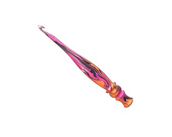 May include: A crochet hook featuring a marbled pattern of vibrant pink, orange, and black colors. The tool has a tapered shaft leading to a hooked tip and a contoured, ergonomic handle with a series of rounded ridges for a secure grip during use.