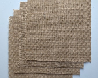 May include: A stack of four brown burlap squares, each with a woven texture.