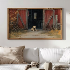 Puede incluir: Pintura enmarcada que representa un golden retriever tumbado en la entrada de un granero rojo. Las puertas del granero están abiertas, revelando un interior oscuro. La obra de arte está ambientada en un paisaje rural, con colores cálidos y una estética rústica.