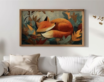 May include: A framed art print depicting a sleeping fox nestled amongst autumnal leaves. The fox is rendered in shades of orange and white, with black ear tips. The artwork is set within a wooden frame and has a warm, inviting colour scheme.