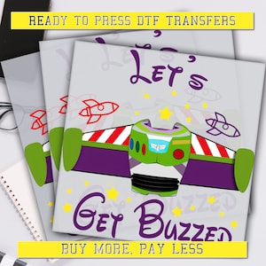 May include: Ready to press DTF transfer design featuring Buzz Lightyear from Toy Story. The design includes Buzz's space ranger helmet, wings, and the text "Let's Get Buzzed".