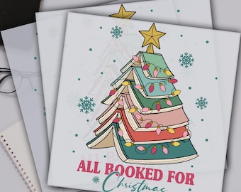 May include: DTF transfer featuring a Christmas tree made of books, adorned with string lights and a star topper. The phrase "ALL BOOKED FOR Christmas" is written below the tree. The text "READY TO PRESS DTF TRANSFERS" is at the top.