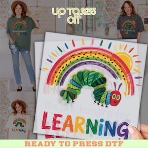 May include: A white graphic featuring a colorful rainbow, a green caterpillar, and the text "We are hungry for LEARNING". The image is a ready-to-press DTF transfer, suitable for t-shirts and other apparel.