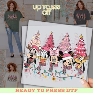 May include: A ready-to-press DTF transfer featuring Disney characters in Santa hats and scarves, with pink Christmas trees and string lights. The text "up to 55% off" is at the top.