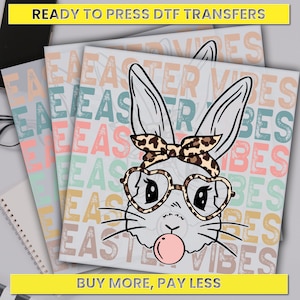 May include: A digital design featuring a cartoon bunny wearing heart-shaped sunglasses and a leopard print headband. The bunny is blowing a bubble and the background is a repeating pattern of the text "Easter Vibes" in various colors.