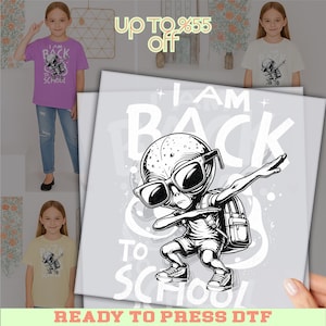 May include: A purple t-shirt with a graphic of an alien wearing sunglasses and a backpack, with the text "I AM BACK TO SCHOOL". The image also shows a white t-shirt with the same graphic. The text "READY TO PRESS DTF" is at the bottom.