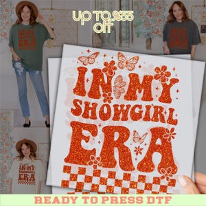 May include: A design featuring the text "IN MY SHOWGIRL ERA" in orange glitter, with butterfly and flower graphics. The design is on a white background with a checkered pattern at the bottom. The words "READY TO PRESS DTF" are at the bottom.