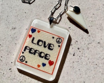 Love and Peace Resin Pendant Necklace. Mixed Media Art Jewellery. Stainless Steel Chain. Ivory Drop Pendant. Alternative Music Gift.