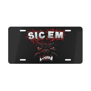 May include: Black and red metal license plate with a white bulldog face and the text "SIC EM" in white letters.