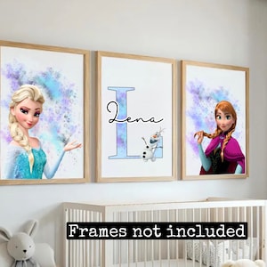 May include: Three framed prints featuring watercolor-style illustrations of Elsa and Anna from Frozen, with a blue and purple background. The middle print features the letter "L" with the name "Lena" written in cursive and a small image of Olaf.