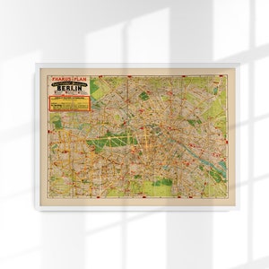 May include: A vintage map of Berlin, Germany, titled "Pharus Plan Fahrplan der Stadt Berlin". The map is printed in black, red, and yellow on a cream-colored background.