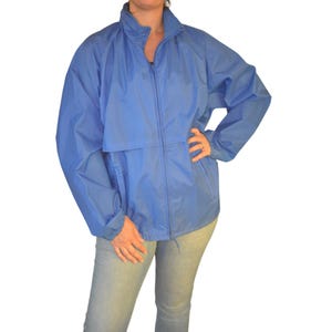 May include: A light blue windbreaker jacket with a zipper closure and a drawstring at the waist.