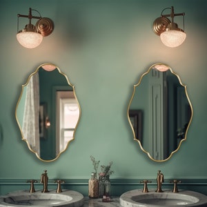 Two Renaissance Mirrors with gold frame hung on the wall of a powder room over a double vanity.