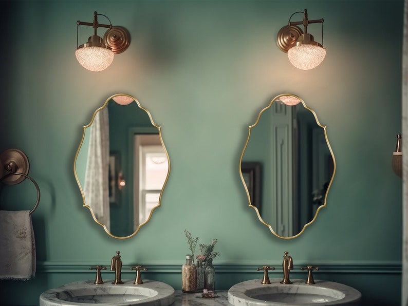 Two Renaissance Mirrors with gold frame hung on the wall of a powder room over a double vanity.