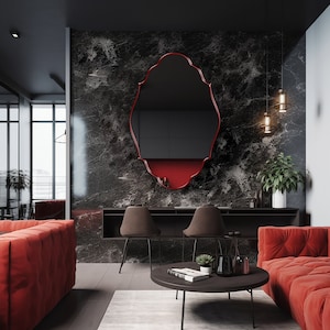 Renaissance Mirror with red frame hung on the wall of a luxury living room.