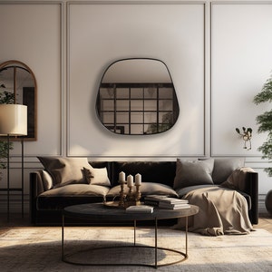 May include: A modern living room interior with a black, irregularly shaped wall mirror, a brown velvet sofa with throw pillows, a round coffee table, a floor lamp, and two potted plants.