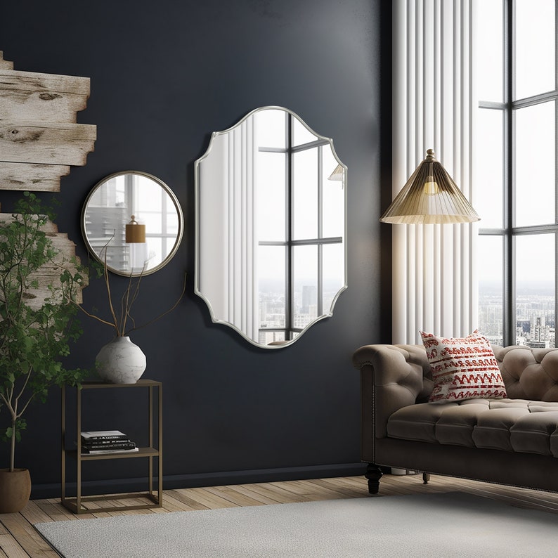 Quatrefoil mirror with silver frame hung over the wall of a living room.