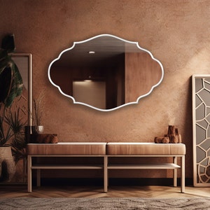 Renaissance Mirror with white frame hung on the wall of an entryway.