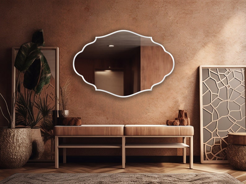 Renaissance Mirror with white frame hung on the wall of an entryway.