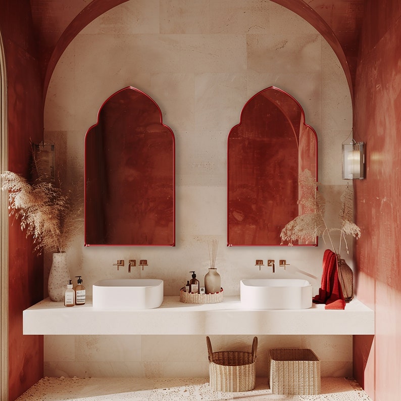 Two Accent Mirrors with red frame finish hung on the wall of a powder room over a double vanity.