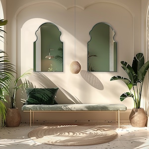 Two Bohemian Arched Mirrors with emerald frame finish hung on the wall of an entryway over a bench.
