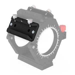 May include: A black metal telescope accessory with two silver knobs and the text "Astro-Physics" printed on the side. The accessory is attached to a larger grey metal ring with a red knob.