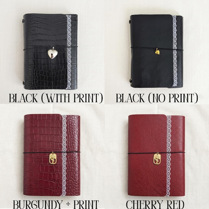 May include: Four rectangular journals featuring a vertical white lace trim and a central elastic band with a metal charm. The top left is black with a crocodile print, top right is smooth black, bottom left is burgundy crocodile, and bottom right is cherry red.