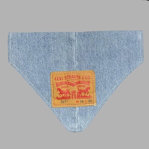 May include: Light blue denim bandana with a stitched edge. Features a rectangular brown leather patch with the Levi Strauss & Co. logo in red. The patch includes text and the number "527" and measurements "W 34 L 32".