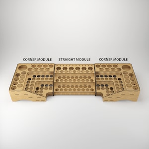 May include: A wooden paint rack with three sections, labeled "Corner Module", "Straight Module", and "Corner Module". The rack has multiple rows of circular holes for holding paint bottles.