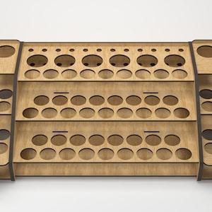 May include: A wooden paint rack with three tiers of circular holes for holding paint bottles. The rack is made of light brown wood with dark brown trim.