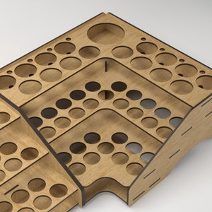 May include: Wooden organizer with multiple circular cutouts for storing small items. The organizer has three tiers and is made of light brown wood.