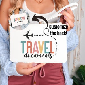 May include: White zippered pouch with a colorful "TRAVEL documents" design and a plane graphic. The back of the pouch can be customized with text.