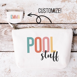 May include: White canvas zippered pouch with the text "POOL stuff" in colorful letters. The pouch is customizable with a name, shown here as "EMMA".