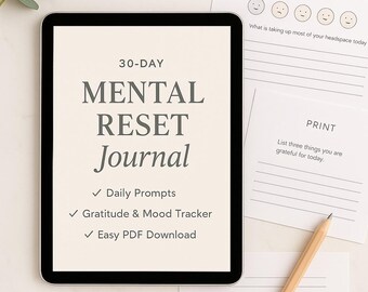 May include: A digital tablet displays a "30-DAY MENTAL RESET Journal" with daily prompts, a gratitude and mood tracker, and easy PDF download. Accompanying it are journal and print pages, along with a pencil, all arranged on a light-colored surface.