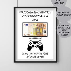 May include: A framed print with a black border. The print features a graphic of a 50 Euro note displayed on a TV screen, with a game controller below. Text includes "HERZLICHEN GLÜCKWUNSCH ZUR KONFIRMATION MAX" and "DEIN STARTKAPITAL FÜRS NÄCHSTE LEVEL!"