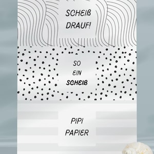 May include: A white and black graphic design with the text "VORSCHAU SEITE 1/5", "SCHEIB DRAUF!", "SO EIN SCHEIB", and "PIPI PAPIER". The design includes wavy lines, polka dots, and horizontal stripes. A seashell and a small white object are in the foreground.